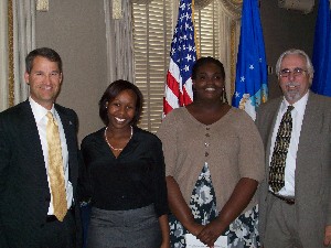 In August, Marion (l) and Skip Foote, American Systems Corporation, present the Vice Adm. Samuel Gravely Memorial Scholarship to Minnae Chabwera (2nd from l) and Sharae Williams, both physics majors at Hampton University.